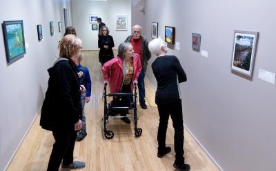 Patrons check out AEO on view at the Accessible Expressions Ohio exhibit opening at Massillon Museum on April 1, 2023. Photo courtesy of Massillon Museum.